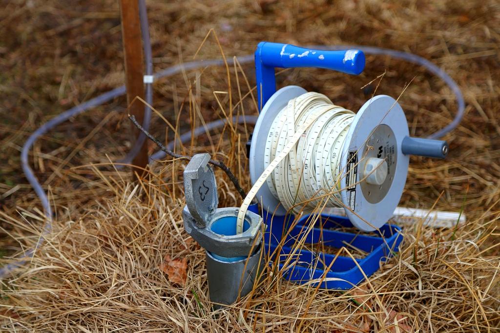 Cross-section illustration of groundwater system with human communities